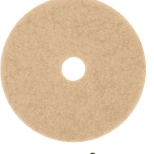 A tan colored circular pad with a small hole in the middle.