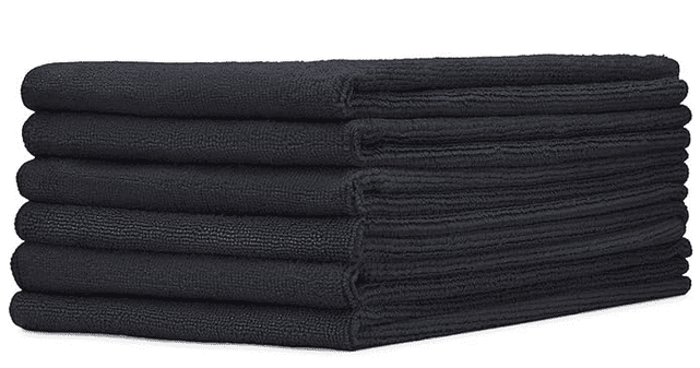 A stack of black towels on top of each other.